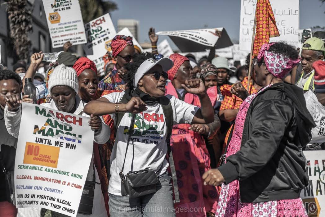 Energetic protest gathering with mixed community members advocating for change